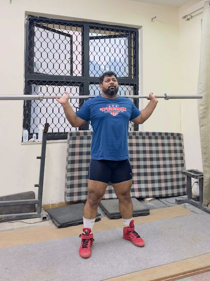 A simple, raw squat hold. This is where it all begins. Perfecting the setup and position before the lift even starts.