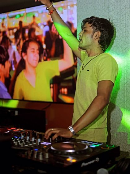 Hand in the air, feeling the music. The screen behind me shows the live feed of the party, connecting everyone.