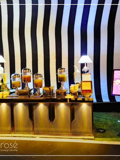 A stylish chaat station with a black and white striped backdrop. We take pride in offering a wide array of culinary options to accommodate various event themes and styles.