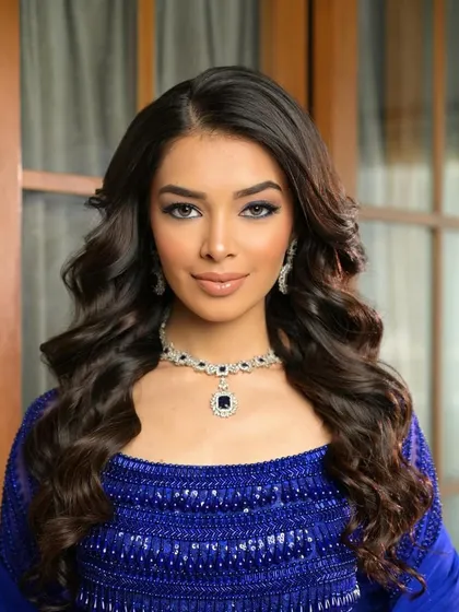 For a glamorous cocktail event, I created this stunning look with a smokey cat-eye and voluminous waves. The deep blue of her dress is complemented by the cool tones in the makeup.