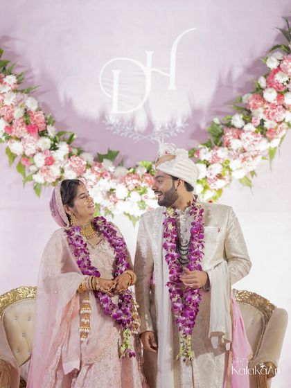 A sweet moment between the newlyweds, framed by their floral backdrop and custom monogram. We always look for ways to incorporate personal details into our shots.