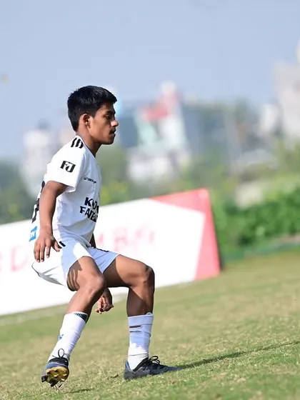A player controlling the ball with precision during a match. This demonstrates the technical proficiency we instill in our academy players.