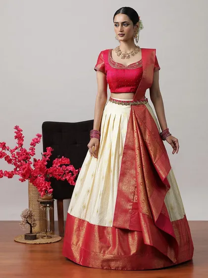 A classic cream and red half-saree lehenga, the epitome of South Indian grace and elegance.