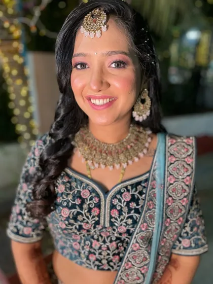 A beautiful reception look with a soft pink eyeshadow and an intricately embroidered lehenga.
