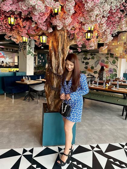 Posing under the pretty pink flowers.