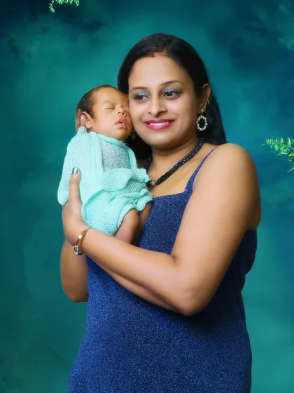 A heartwarming photo of a mother holding her newborn baby. I conduct these newborn shoots in the comfort of your home to ensure both mother and baby are relaxed.