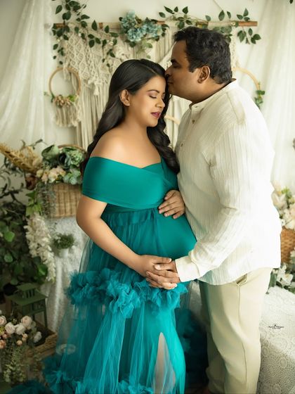 A tender moment with a loving kiss on the forehead. This pose is especially poignant in a twin pregnancy shoot, celebrating the double blessing.