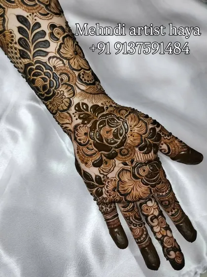This angle highlights the seamless transition from the hand to the arm in this full-sleeve bridal henna.