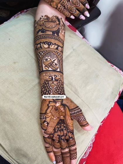 A beautiful bridal mehandi with a romantic couple portrait. The design is enhanced with traditional motifs like wedding rings, elephants, and swans, symbolizing love and commitment.