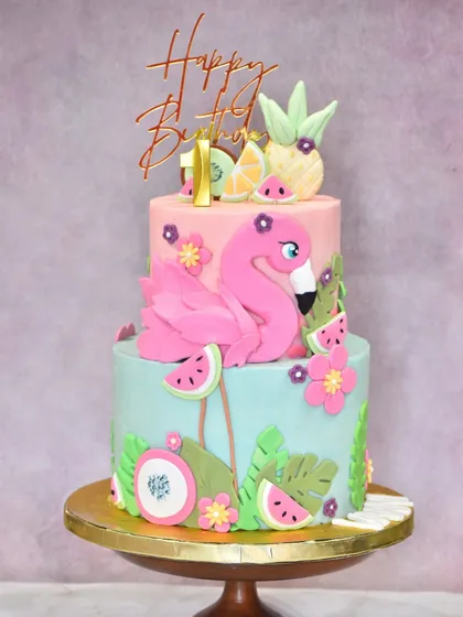 A duplicate of image 25, showing the two-tier tropical flamingo cake.