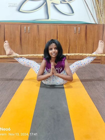 Using a prop to explore a deep stretch in this wide-legged seated forward bend. Props help make poses more accessible and allow kids to safely explore their flexibility.