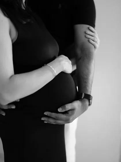 Sometimes, the most powerful stories are told in the details. This black and white close-up of their hands embracing the baby bump is timeless and full of emotion. It’s a simple, artistic shot that symbolizes protection, love, and connection.