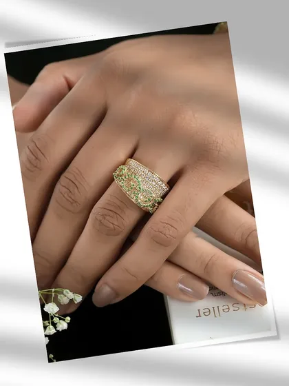 A symphony of diamonds and peridots, crafted for the bold and beautiful. This wide, intricate ring is not just a piece of jewellery; it is a unique customization that is entirely yours.