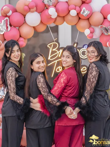 The bride and her bridesmaids in matching robes, a classic and cute shot for any bachelorette party.
