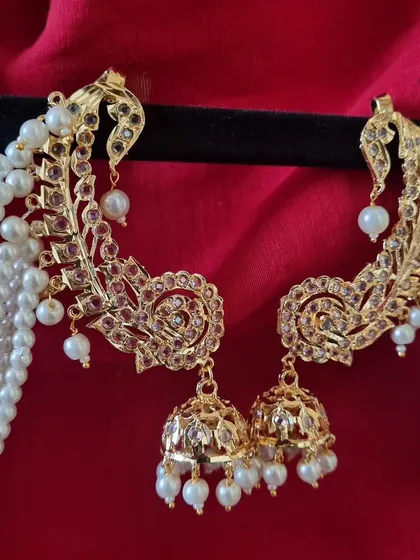 A close look at our gold-plated Hyderabadi Kimaya Earcuffs. Notice the intricate Jadau work and the cascade of pearls. This is a statement piece that blends royal heritage with modern craftsmanship, perfect for a bride or a wedding guest.