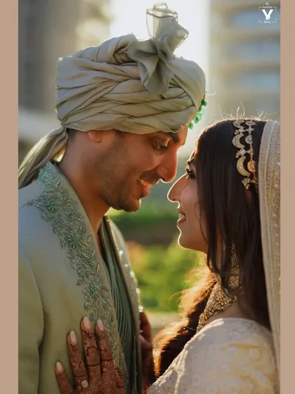 A close-up portrait filled with warmth and affection. The golden hour light beautifully illuminates their happy expressions, capturing the essence of their love story in Mumbai.