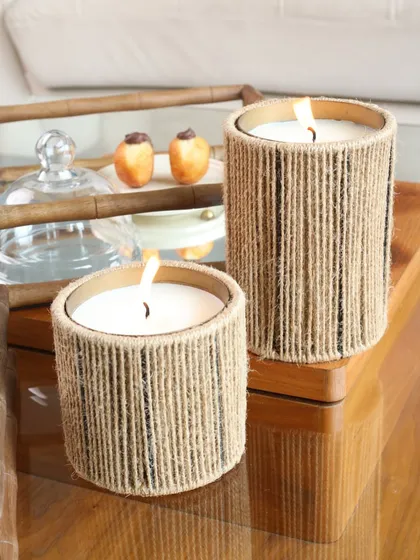 A close-up of our jute-wrapped candles, their natural texture contrasting beautifully with the sleek surface of our mirror trays. It’s a look that is both sophisticated and effortlessly chic.