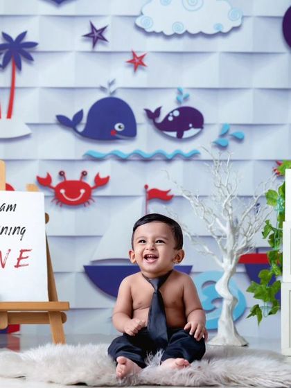 Turning one is a big deal! This shot from my nautical-themed cakesmash series shows the setup before the smashing begins, complete with "ONE" blocks and a cheerful backdrop.