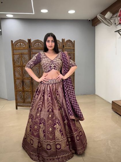 A rich purple Banarasi-style lehenga with traditional motifs. This pre-loved piece offers a classic, royal look with a modern crop top silhouette.