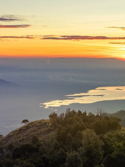 A telephoto shot of the layers of the Nilgiri hills at sunrise, seen from Kodanad. The morning light creates a beautiful color gradient in the sky.