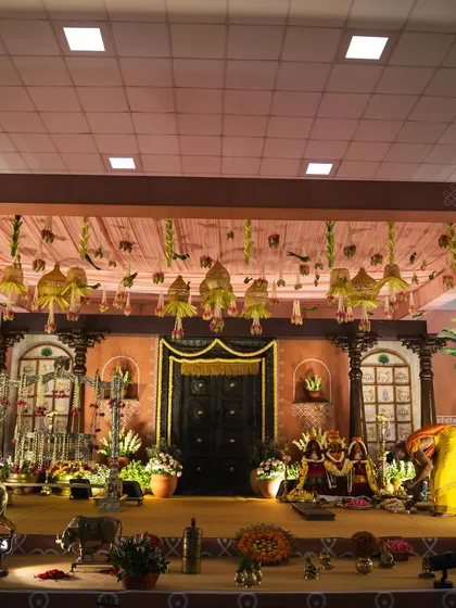 We designed this elaborate stage for little Mitharv's naming ceremony, creating a "South Indian village" theme. The decor featured a traditional door, terracotta tones, and vintage elements to bring the nostalgic concept to life.