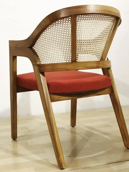 Cane and teak wood is a classic combination that is very popular right now. This armchair features a curved back with natural cane weaving, making it both stylish and comfortable. It’s a versatile design that works well in living rooms, bedrooms, or even cafes.