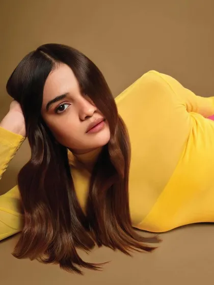 A creative pose from the Schwarzkopf "Oneself" shoot. The makeup is fresh and minimal, with a focus on a dewy complexion that looks radiant and natural, even in a more artistic shot.