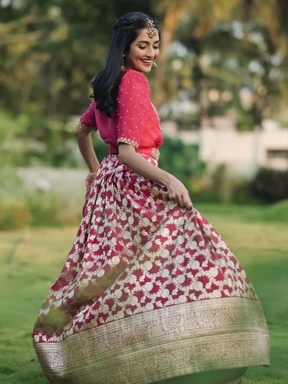 The joy of movement is captured in this shot of our client twirling in her rose pink Banarasi lehenga.