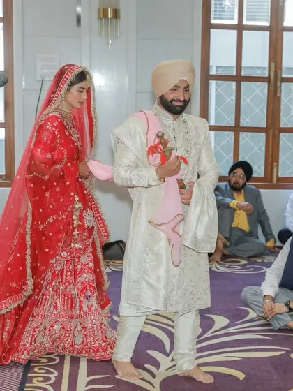 The bride and groom during the Laavan Pheras of an Anand Karaj ceremony. This shot captures the solemnity and grace of the Sikh wedding tradition.