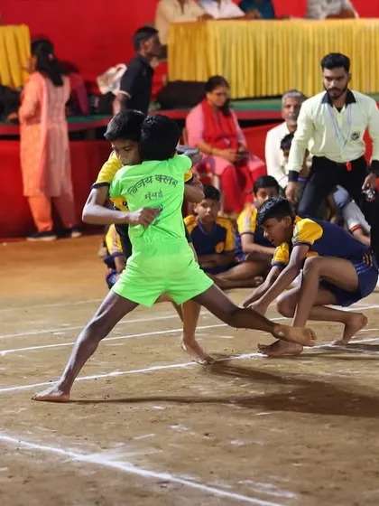 An Under-14 player attempting a toe touch during a competitive match.