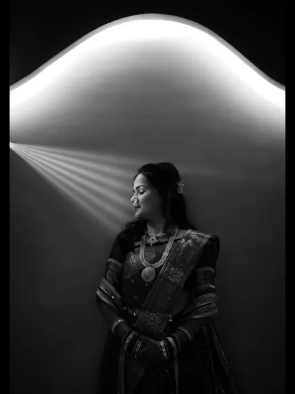 A beautiful black and white portrait of the bride, artistically lit from above to create a serene and timeless image.