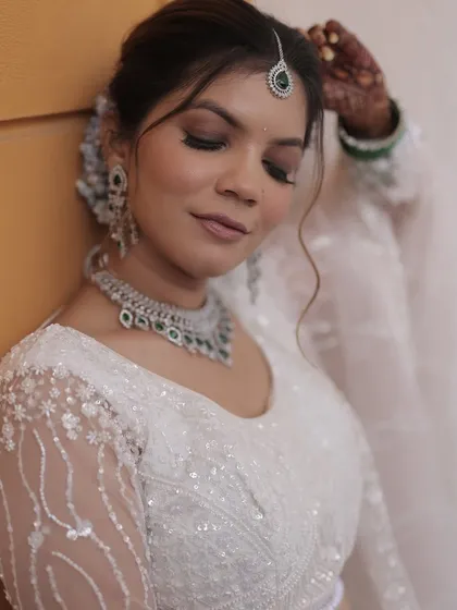 A close-up showing the beautiful details of the bride's hairstyle and makeup.