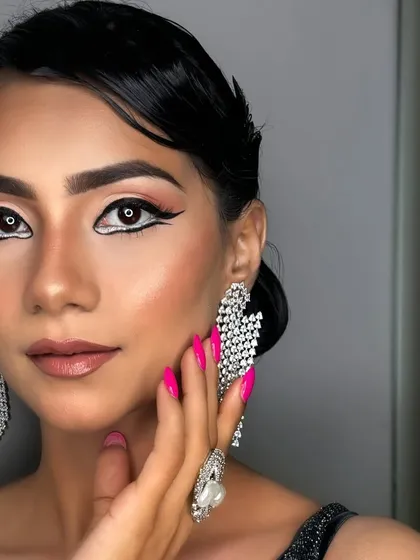 A symphony of black and silver. This look is all about high-contrast glamour, with a bold graphic liner and sparkling diamond accessories.