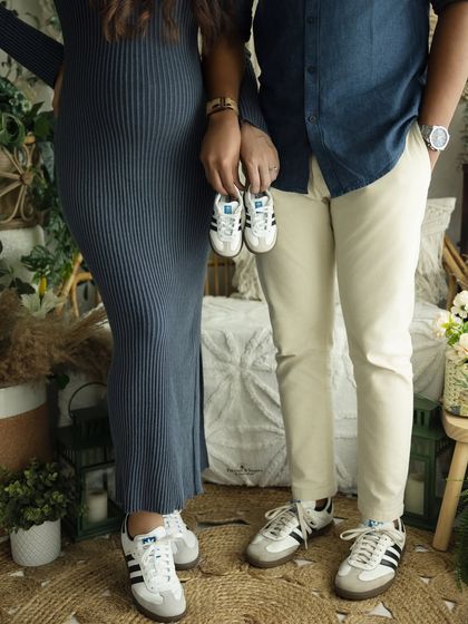 A creative and fun shot focusing on the family's matching sneakers. This is a great way to announce the arrival of a new little member to the team.