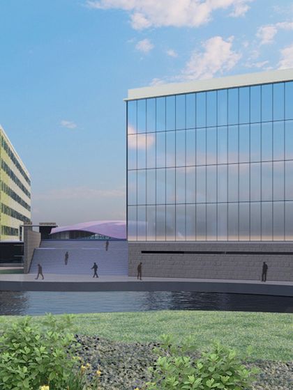 This rendering shows a commercial complex by the water, with a modern glass building and a green-facade structure. We are grateful for the chance to bring creativity to life, blending innovation with timeless design.