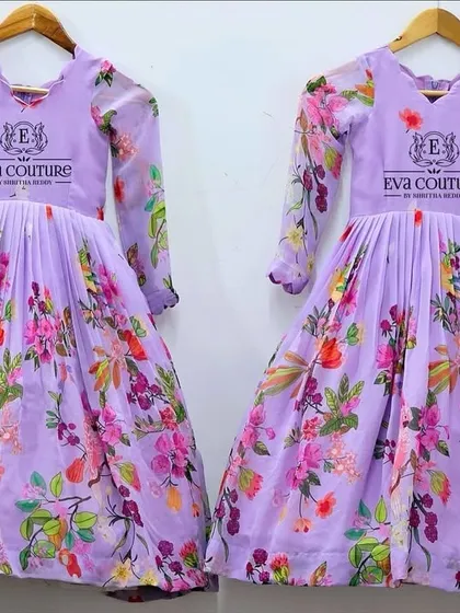 A beautiful floral printed organza gown in a lavender shade. The long sleeves and pleated skirt create an elegant silhouette.