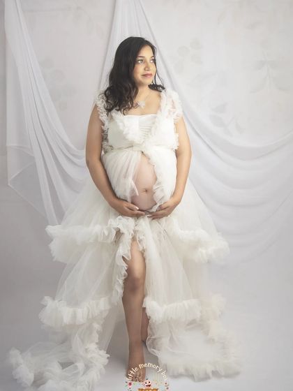 This dreamy white gown with its ruffled layers adds so much texture and romance to the portrait. It’s perfect for moms who want to feel like a goddess.