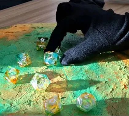 A behind-the-scenes look at our "Vision of a Thousand Galaxies" video shoot. Our team carefully places the dice on a custom-painted, textured board to create a unique, otherworldly scene.