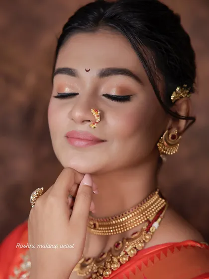 A close-up of the soft, neutral eye makeup and lipstick, a perfect choice for a classic bridal look.
