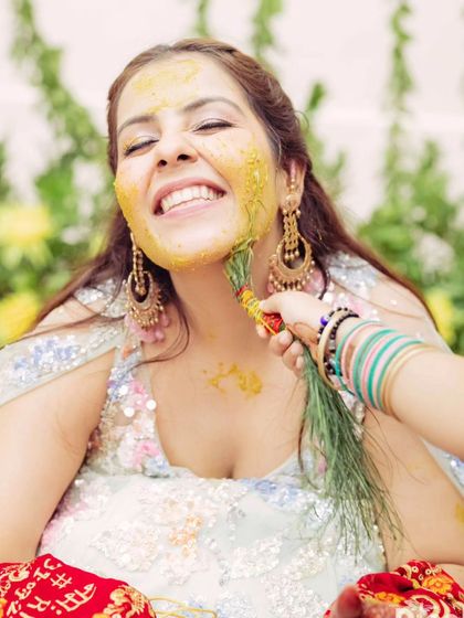 A close-up of the Haldi application. Her skin is prepped to be protected, and the makeup is set to be long-lasting.