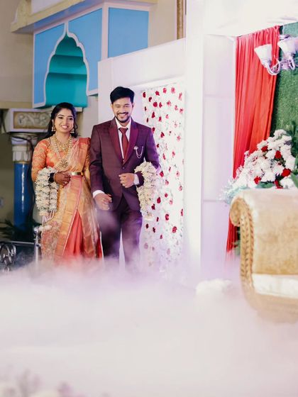 The couple makes their grand entrance through a cloud of smoke, creating a dreamy and dramatic start to their reception celebration.