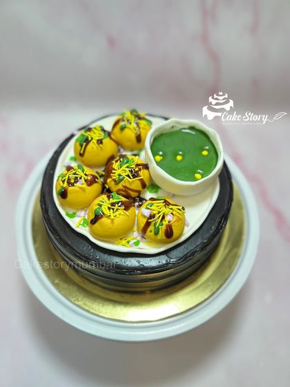A side view of the Pani Puri cake, showing the rich chocolate cake base.