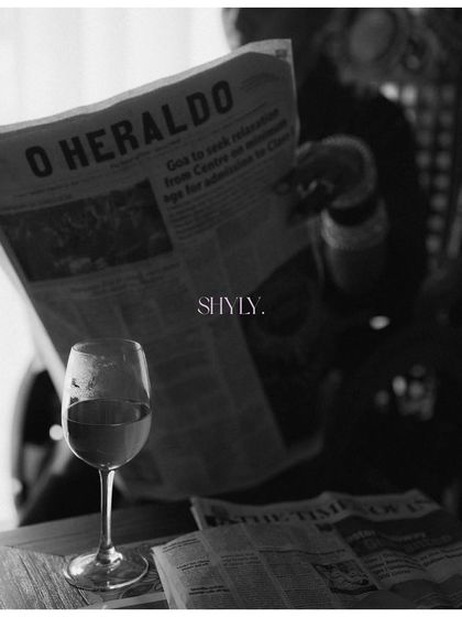 A moody and artistic version of the newspaper bridal portrait. The focus on the wine glass and the deep shadows create a dramatic, fine-art image.