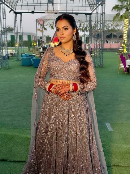 The full reception look, set against an outdoor backdrop. The makeup is designed to be both glamorous and long-lasting for a night of celebration.