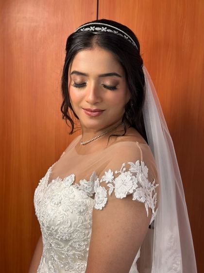 An eyes-closed shot to showcase the soft, neutral-toned eyeshadow and the flawless, dewy finish of her skin. It's a look of pure, serene elegance.