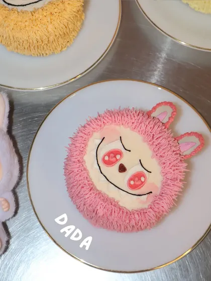 This is Dada, the pink character from our Labubu cake collection. We love the little blush details on this one.