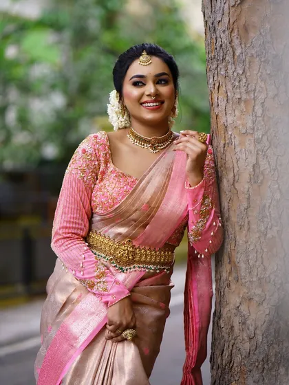 A happy client in a beautiful pink and gold silk saree for an outdoor event. My goal is always a flawless drape that lets you feel confident and at ease, no matter the occasion.