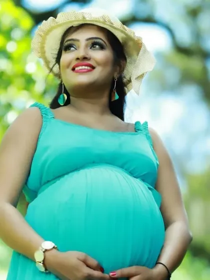 The beautiful smile of a mom-to-be, complemented by the fresh color of our aqua pleated gown. It’s a wonderful choice for capturing the happiness of this special time.