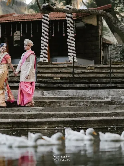 A couple walks by the pond, where our resident ducks swim peacefully, adding a unique and charming element to their wedding photos.