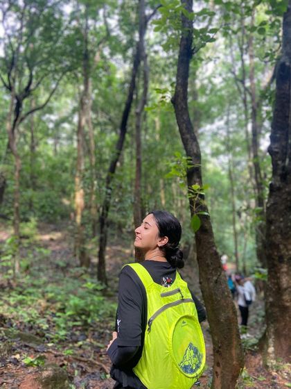 A trekker enjoying the serene forest path on the way to Kodachadri peak.